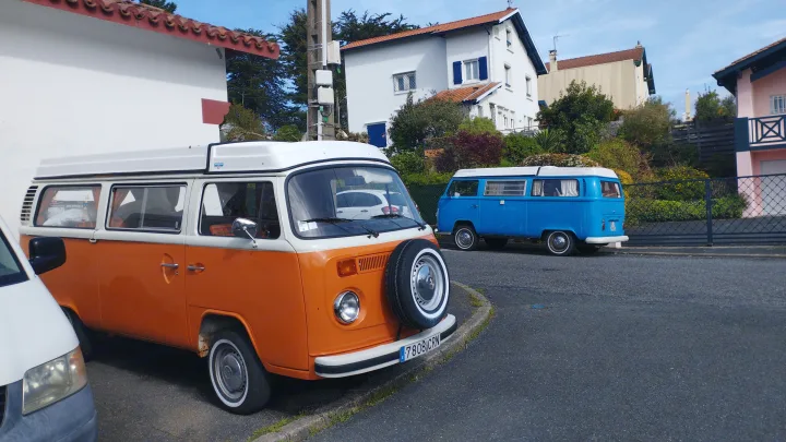 Vintage orange and blue VW camper vans, great RV rental for sunny adventures.. Volkswagen T2 Westfalia 1978