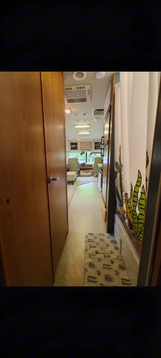 Explore this RV rental's cozy interior, featuring a bright hallway leading to the cockpit, plus a fun cactus-themed shower.. Fleetwood Other 2006