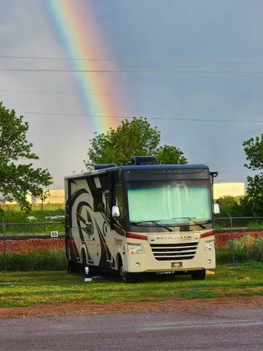 Beautiful rainbow over a parked Coachmen Mirada RV, perfect for your next rv rental adventure or camping trip.. Coachman Mirada 2018