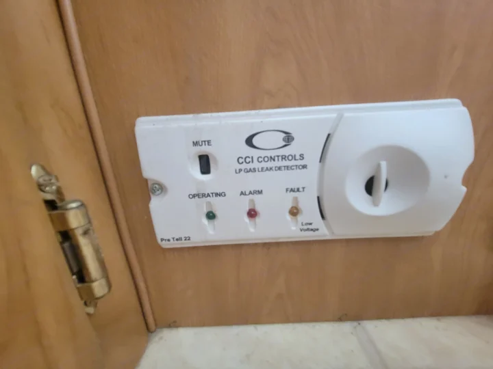 An LP gas leak detector, essential safety for an RV rental. Displays operating, alarm, and fault status lights for user awareness.. Coleman Taos 2003