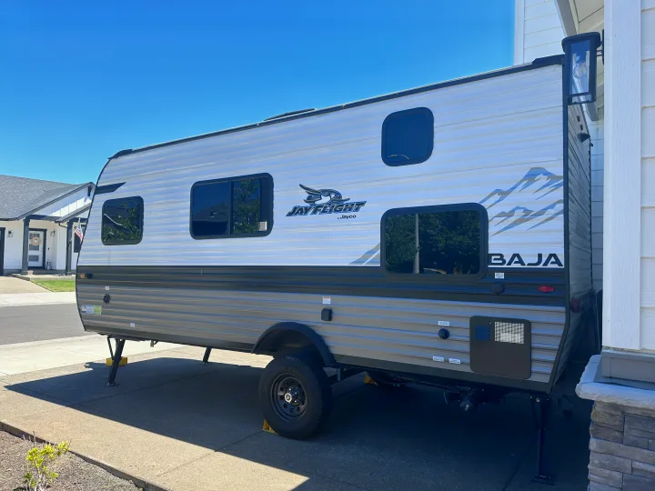 Bright day for your next RV rental! This silver Jay Flight Baja travel trailer is parked, ready for adventure.. Jayco Jay Flight SLX Baja Edition 2022