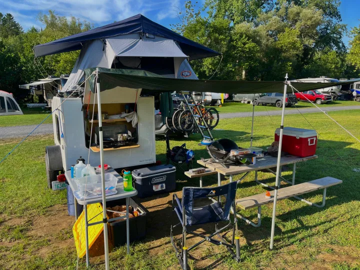 An RV rental camper trailer with a roof-top tent, shaded outdoor kitchen, bicycles, and picnic area for camping.. Other Other 2020