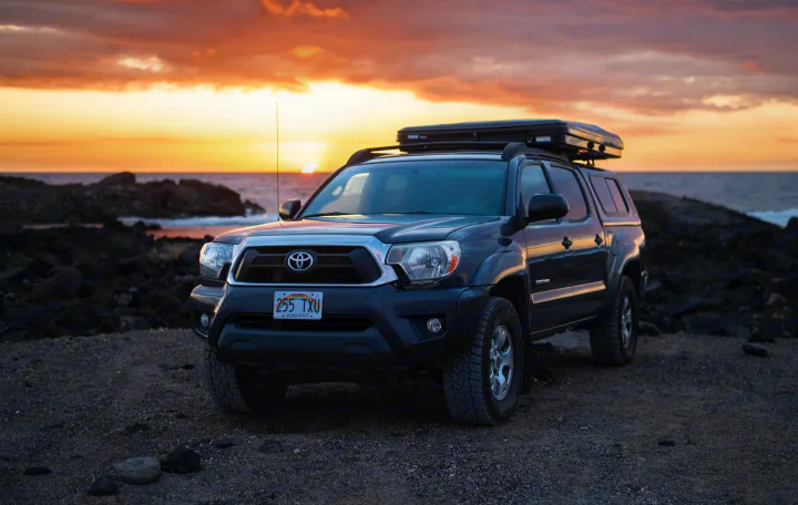 Hawaii: Toyota Tacoma with rooftop tent, parked by the ocean at sunset. A unique RV rental option for adventure travel.. Other Other 2013