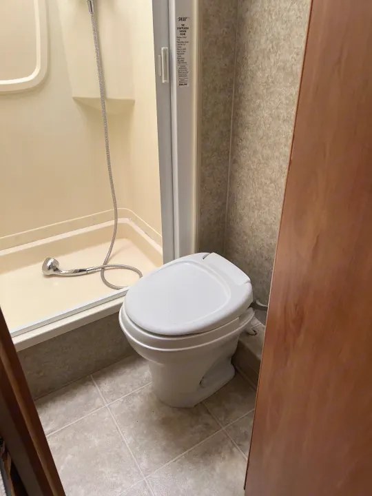 This RV rental offers a practical bathroom with a space-saving shower and toilet.. Winnebago Chalet 2010
