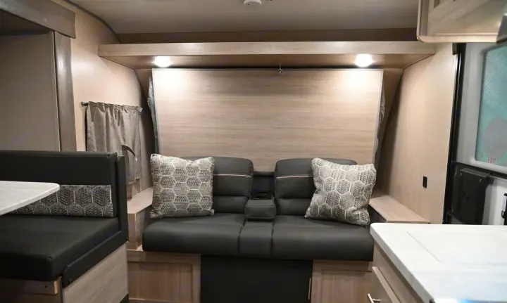 Modern RV rental living area with a cozy gray sofa, dinette, and contemporary finishes. Ready for adventure!. Coachmen Catalina Summit 184BHS 2022