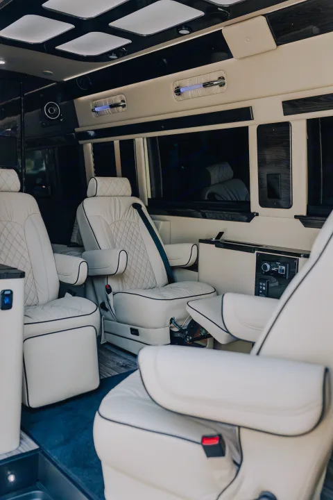 Step into comfort with this luxury RV rental's spacious interior, featuring plush captain's chairs and mood lighting.. Ultimate Toys Ultimate Coach 2023