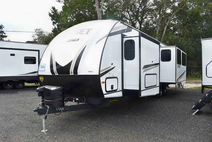 Modern white travel trailer RV rental with extended slide-out, ready for your camping trip.. Crossroads RV Sunset Trail Super Lite 2023