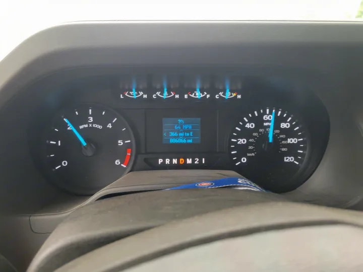 RV rental dashboard shows 64 MPH, 006066 miles. Digital display, speedometer, tachometer, fuel, and temp gauges are visible.. Solera Solera Motorhome 2022
