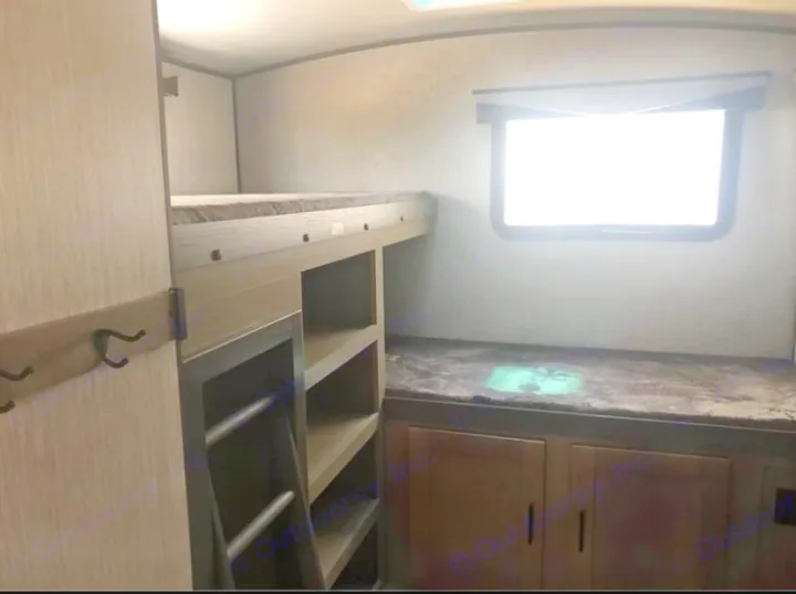 Experience comfort in this rv rental bunkhouse: features bunk beds, built-in storage shelves, and a bright window.. Cruiser Rv Corp Twilight 2021