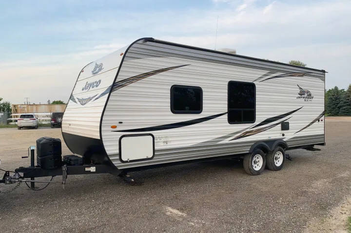 Jayco Jay Flight SLX travel trailer RV rental, light grey/white, on gravel. Ready for adventure!. Jayco Jay Flight SLX 2019