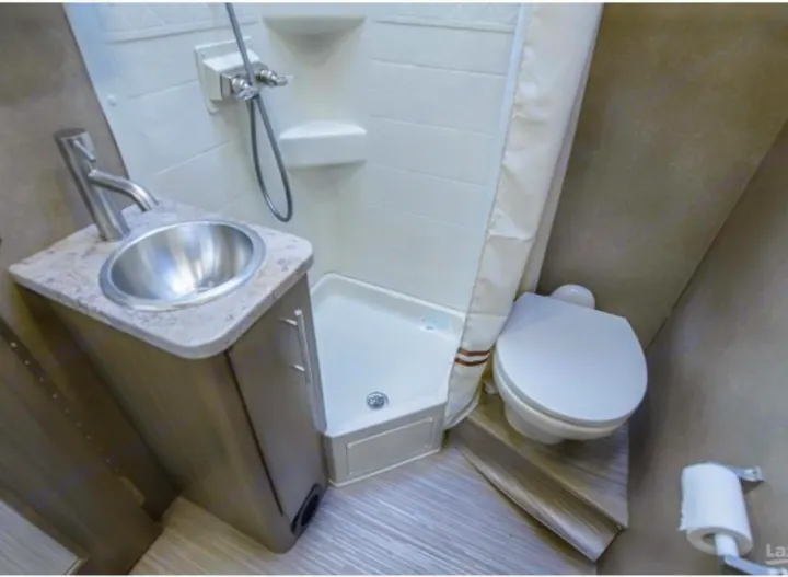 Compact RV rental bathroom: sink, shower, toilet. Efficient design for comfortable travels.. Thor Vegas 2018