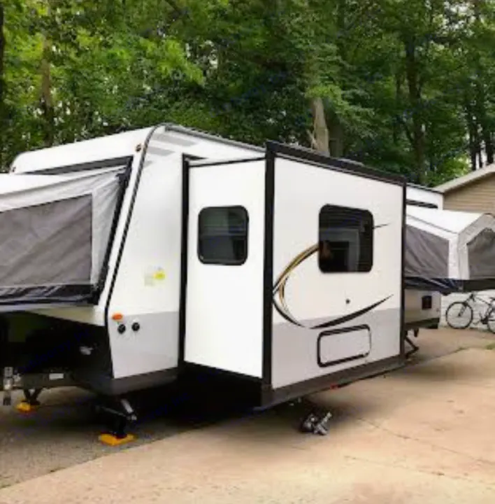 Experience the outdoors! This white and grey hybrid RV rental, a pop-up travel trailer, is ready for your adventure.. Forest River Rockwood Roo 2019