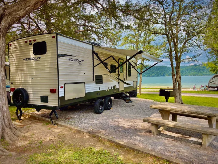 Perfect lakeside RV rental campsite with a travel trailer, picnic table, and grill. Enjoy nature!. Keystone RV Hideout LHS 2019