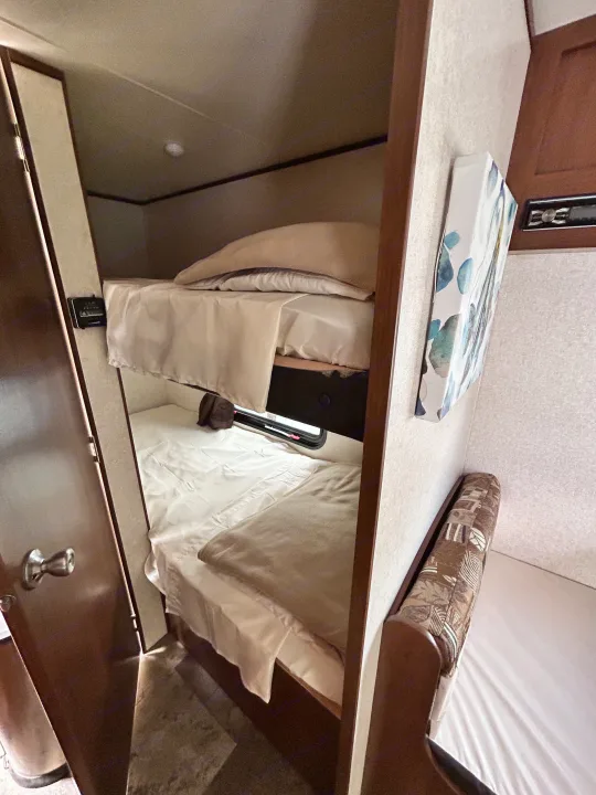 Your RV rental adventure awaits! Cozy bunk beds and compact interior space for comfortable travel accommodation.. Jayco Jay Flight SLX 2017