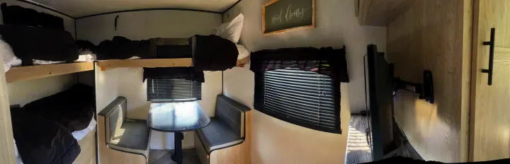 Experience comfort in this RV rental's cozy interior, featuring bunk beds, a dinette, and entertainment, perfect for family adventures.. Heartland RVs Prowler 2022
