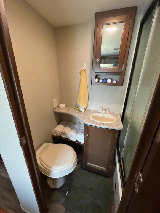 Compact RV rental bathroom with toilet, sink, and clever storage for a comfortable journey.. Keystone RV Bullet Ultra Lite 2016