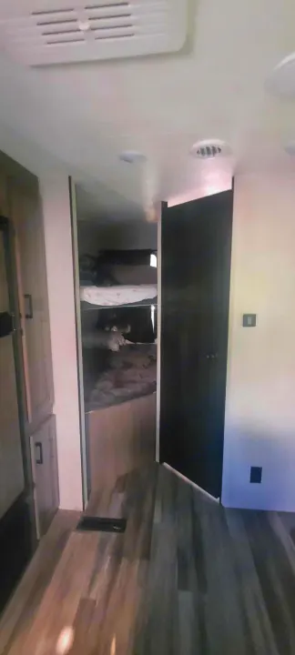 RV rental interior featuring a cozy bunk bed area, sleek flooring, and modern amenities.. Starcraft Autumn Ridge 2022