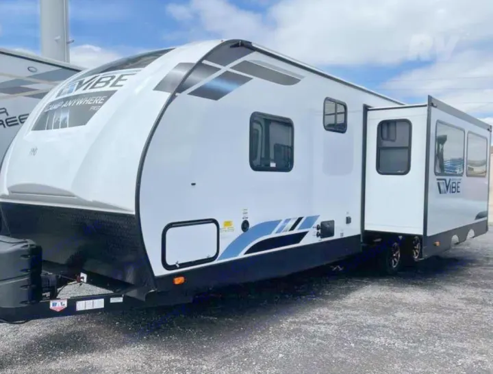 Spacious white Vibe travel trailer with extended slide-out and blue graphics. Great for your next RV rental trip.. Forest River Vibe 2022