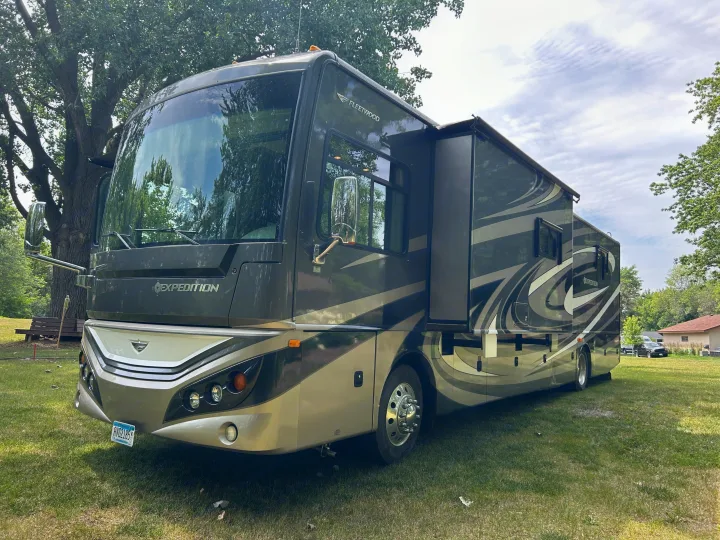 Spacious Fleetwood Expedition Class A RV rental parked outdoors on a grassy site, ready for your next adventure.. Fleetwood Expedition 38B 2011