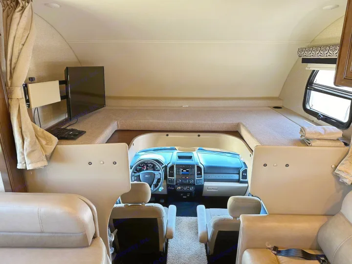 Spacious RV rental interior with overhead bunk, TV, and Ford Super Duty dashboard. Ready for your next adventure!. Thor Four Winds 2017