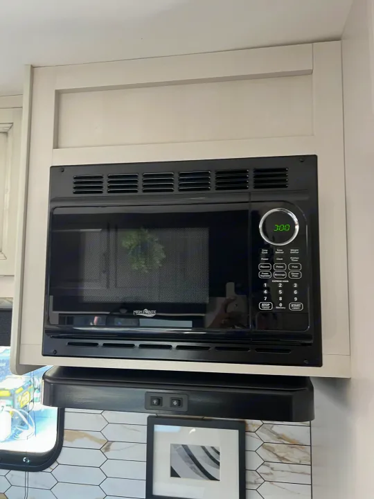 Compact RV kitchen setup: High Pointe microwave and range hood, ready for your next rv rental.. Jayco Featherlight SLX8 2022