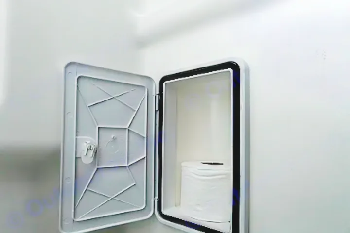 RV rental bathroom: Secure, compact storage with toilet paper inside a sealed wall compartment.. Winnebago Solis PX 2024