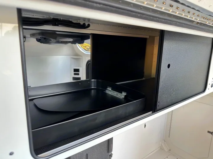 RV rental: Well-organized interior storage compartment with a large black utility tray and sliding access panel.. Mammoth Overland Mammoth HV 2023