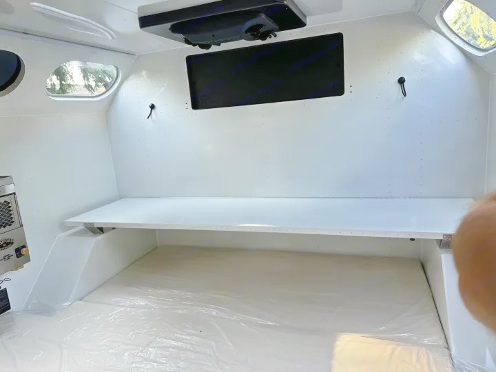 RV rental: Clean white camper interior with new bed, overhead shelf, and windows. Perfect for travel adventures.. Mammoth Overland Mammoth HV 2023