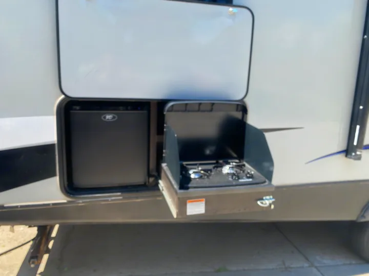 RV rental with convenient outdoor kitchen: a mini-fridge and two-burner stove. Enjoy easy outdoor cooking on your trip!. Keystone RV Bullet Ultra Lite 2019