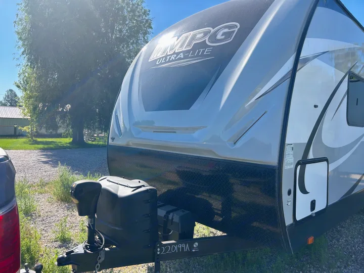 Grey & black MPG Ultra-Lite travel trailer RV rental, parked on gravel, ready for adventures.. Cruiser Rv Corp 2450RK 2019