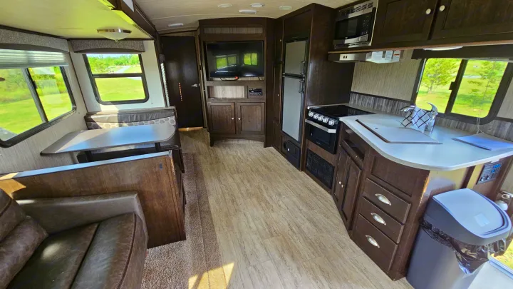 Step inside this modern rv rental, featuring a full kitchen with appliances, comfortable dinette, and living area.. Cruiser RV Shadow Cruiser 2019