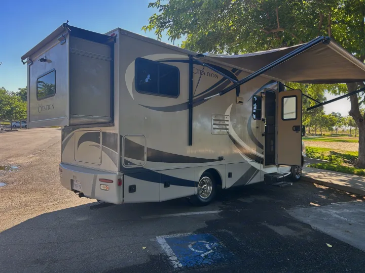 Large Citation RV rental with rear slide-out extended and awning deployed, ready for travel.. Thor Citation 2015