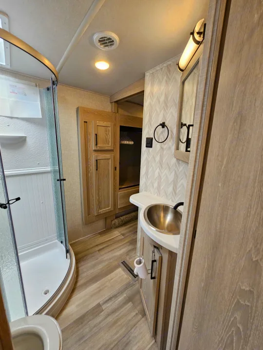 RV rental: Clean, modern bathroom with vanity, sink, mirror, cabinetry & spacious shower. Ideal for your next adventure.. Forest River Flagstaff Super Lite 2022