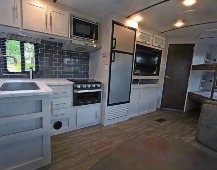 Step inside this modern RV rental with a fully equipped kitchen, comfy bunk beds, and bright living area.. Keystone RV Bullet Ultra Lite 2021