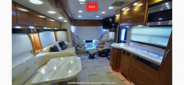 Spacious luxury RV rental interior with bright living area, kitchen, and dining, offering comfortable travel.. Monaco Vesta 2012