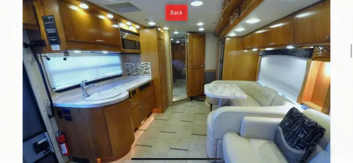 Inside this luxury RV rental, find a full kitchen, comfortable dining booth, and living area with plush seating.. Monaco Vesta 2012