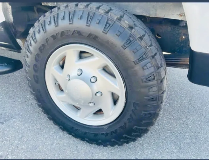 Goodyear Wrangler tire & Ford wheel on an RV rental. A sturdy setup ready for your next road trip adventure.. Ford Econoline 2012
