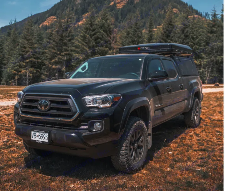 Black Toyota Tacoma pickup with a rooftop camper, ideal for adventure or an RV rental. Ready for overlanding.. Toyota Tacoma 2023