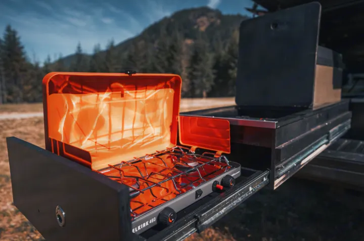 RV rental ready! This pull-out outdoor kitchen features an orange camp stove, perfect for wilderness cooking.. Toyota Tacoma 2023