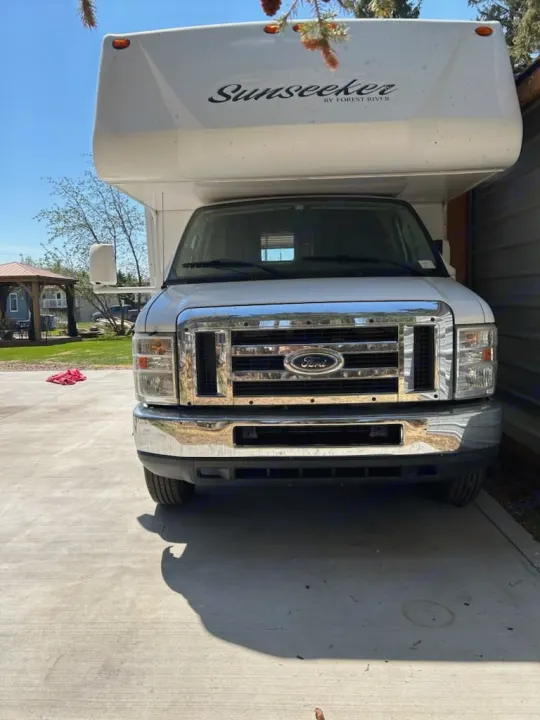 Front view of a white Sunseeker RV, a Ford motorhome, parked on concrete, ready for your next RV rental adventure.. Forest River Sunseeker 2010