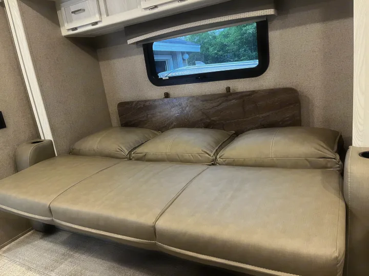 This RV rental offers a versatile sleeper sofa setup with soft cushions, convenient cabinets, and a window view.. Forest River Rockwood Geo Pro 2020