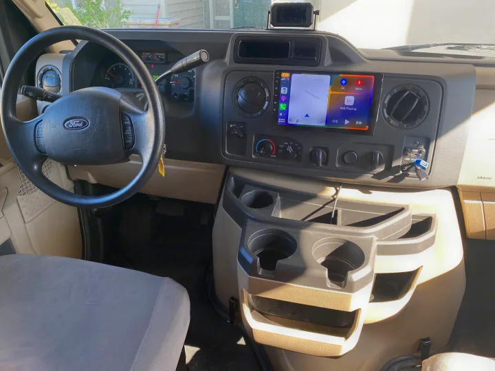 Inside a modern Ford rv rental dashboard: Apple CarPlay, TPMS, & climate controls for a smooth journey.. Thor Freedom Elite 2019