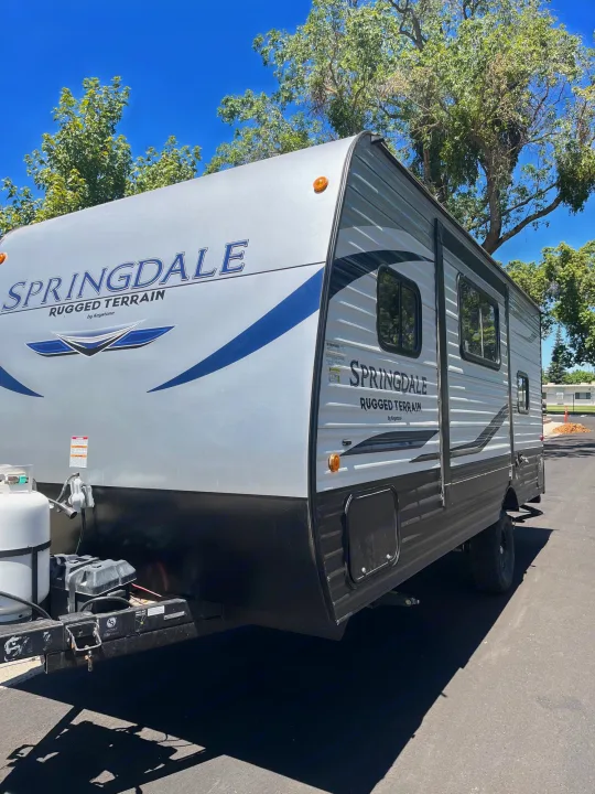 New Springdale Rugged Terrain RV rental, ideal for outdoor adventures and camping trips. Silver & black travel trailer.. Keystone RV Springdale 2021