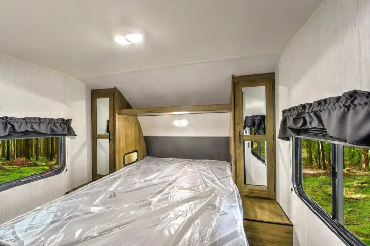 Queen bed. Each nightstand has outlet and light. Roomy storage!. Heartland RVs Pioneer 2023