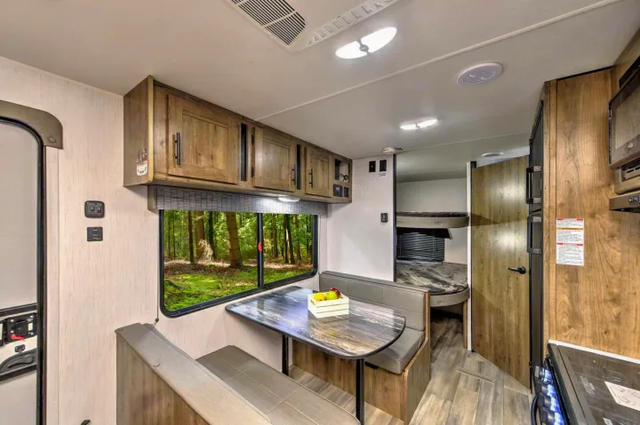 Dining area, above is stereo system. Stereo has two zones, one inside one outside.. Heartland RVs Pioneer 2023
