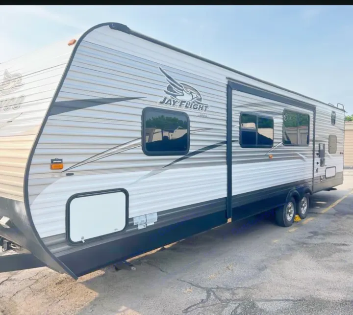 A modern Jayco Jay Flight travel trailer, ideal for an RV rental. Features a spacious design, multiple windows, and dual axles.. Jayco Jay Flight 2016