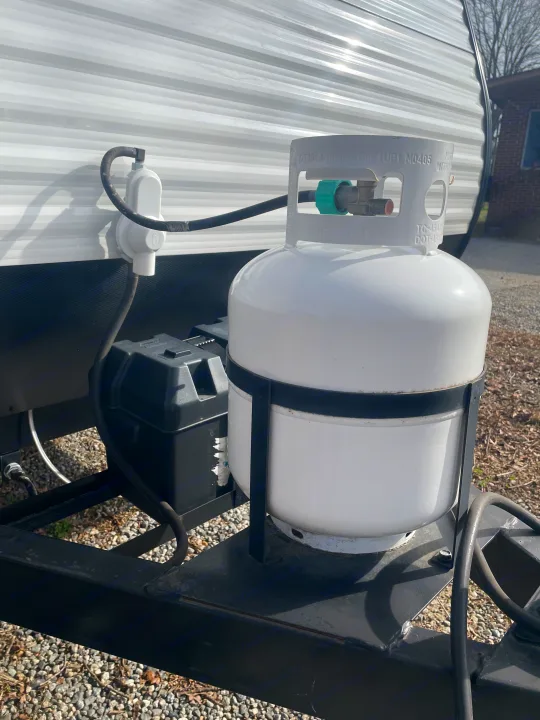 RV rental: White propane tank & black battery on the hitch. Ready for adventure on your next trip.. Dutchmen Coleman Lantern LT 2019