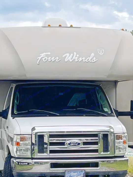 Front view of a white Ford Class C RV. Thor Four Winds 2015