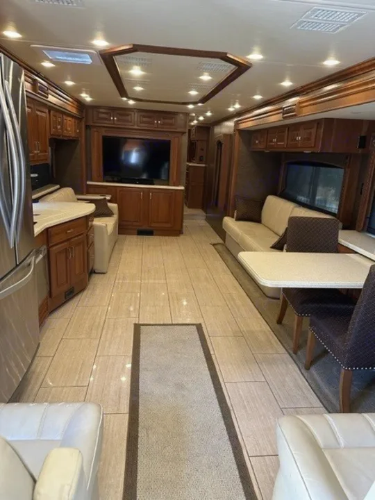 Spacious luxury RV rental interior: large living area with TV, kitchen, and dining for comfortable travel.. Holiday Rambler Endeavor 2017