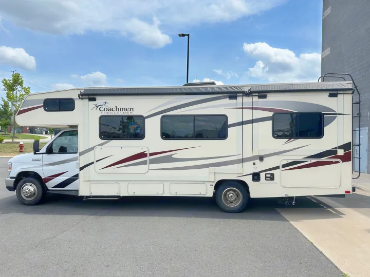 Side view of a clean white Coachmen Freelander RV, perfect for your next rv rental adventure. Note its sleek stripe design.. Forest River Coachmen Freelander 2018